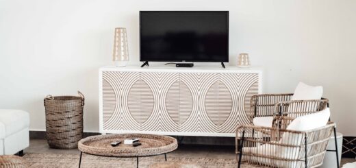 Modern living room showcasing integrating baskets into your home storage, with a large wicker basket beside a stylish media console and basket chairs around a coffee table